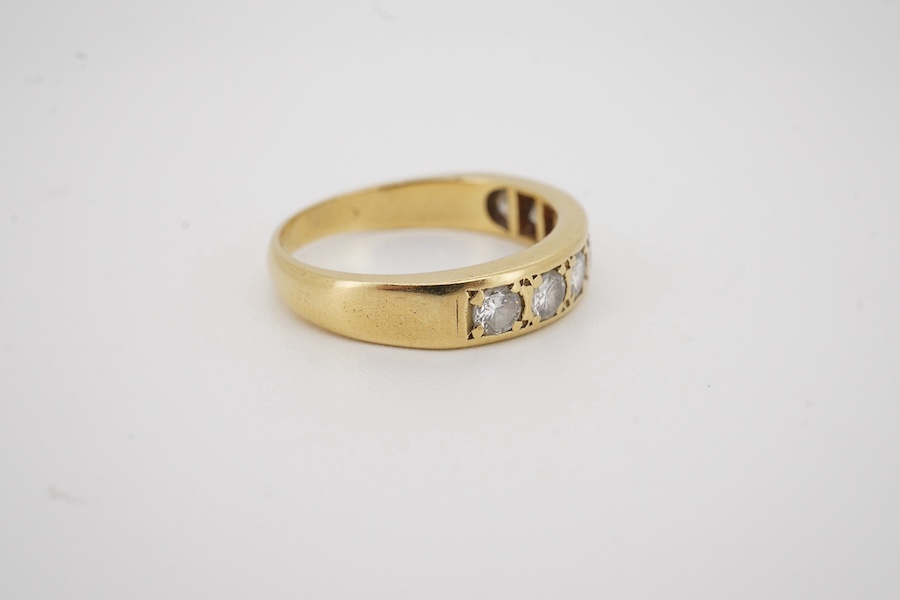 A modern 18ct gold and seven stone diamond set half hoop ring, size M, gross weight 4 grams.
